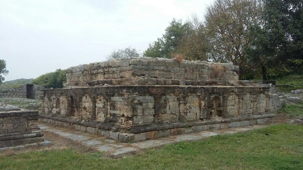 Stone stupa base with carved niches at Jaulian Buddhist monastery, Taxila UNESCO site